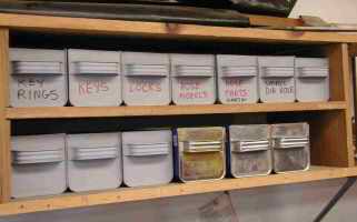 Storage bins on wall mounted shelf